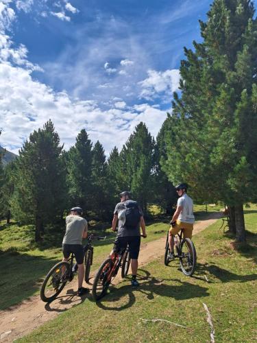 three people riding bikes on a dirt road at Apart am Brunnen in Ried im Oberinntal
