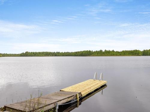 a dock in the middle of a large lake at Holiday Home Koppelomaa by Interhome in Puolanka