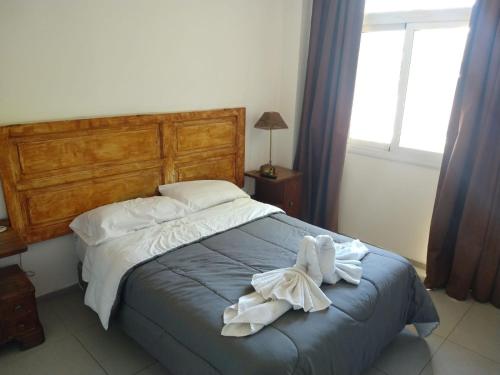 a bedroom with a bed with towels on it at TAMBO LIBERTADOR in San Juan