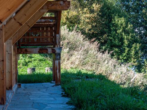 a walkway leading to a wooden building with grass at Chalet Skyfall by Interhome in Les Collons