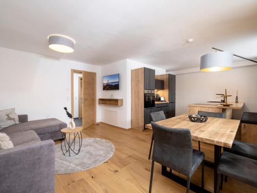 a living room with a couch and a table at Apartment Deluxe Bergblick 10 by Interhome in Söll