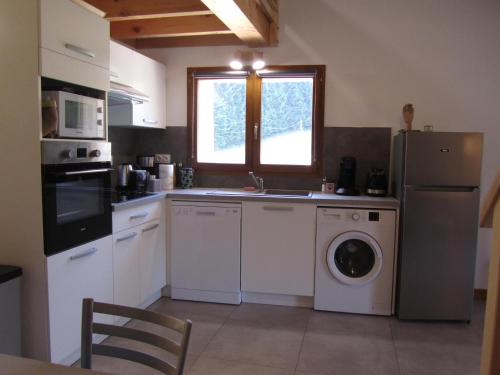 a kitchen with a sink and a washing machine at GÎTE de DRAGOUX in Bas Bouvante