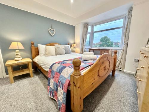 a bedroom with a bed and a window at Crocus Cottage in York