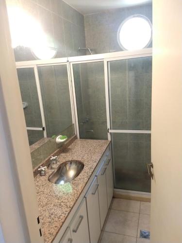a bathroom with a sink and a shower at TAMBO LIBERTADOR in San Juan