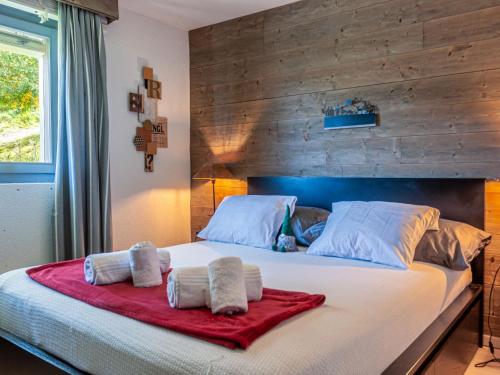 a bedroom with a large bed with towels on it at Apartment Victoria 1 D2 by Interhome in Nendaz