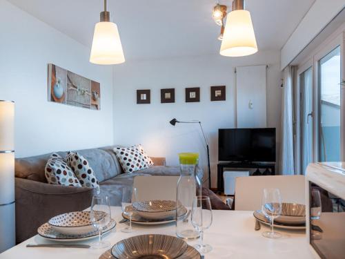 a living room with a table and a couch at Apartment Olympic C7 by Interhome in Nendaz