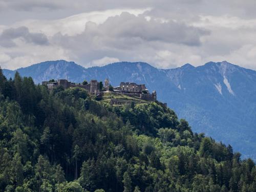 a castle on top of a hill in the mountains at Apartment Terrassentraum alpe maritima Ski&See-15 by Interhome in Annenheim