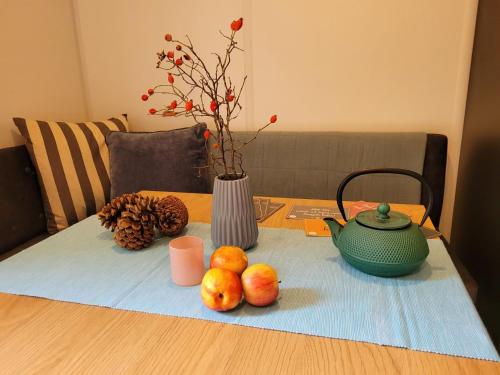 a table with a teapot and fruits on a table at Holiday Home Tiny Haus Soul & Lake by Interhome in Wemding