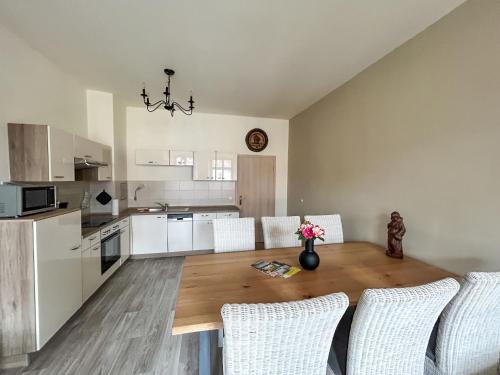 a kitchen with a wooden table and chairs in a kitchen at Apartment Anno 1529 - Malzmönch Laurentius by Interhome in Zittau
