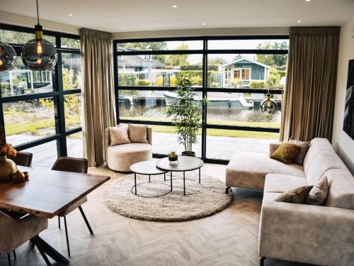 a living room with a couch and a table at Holiday Home Villa Nautica 6 persoons by Interhome in Loosdrecht