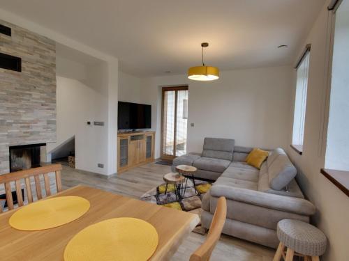 a living room with a couch and a table at Apartment U Krále-2 by Interhome in Kořenov