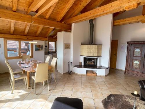 a kitchen and dining room with a table and a stove at Apartment Penthouse Brugg by Interhome in Amden