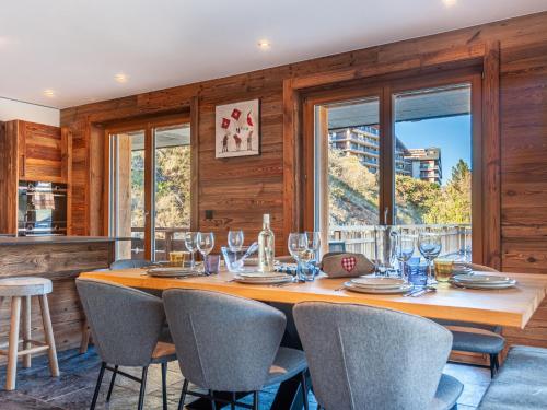 a dining room with a large wooden table and chairs at Apartment Ferme D'Alice A2 by Interhome in Nendaz