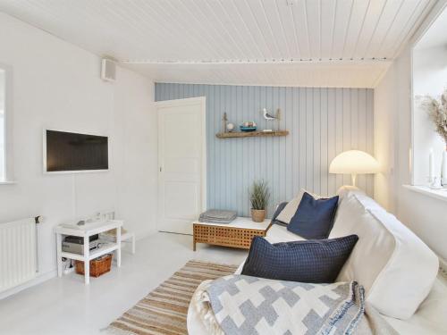 a living room with a couch and a table at Apartment Heidel - 400m from the sea in NW Jutland by Interhome in Skagen