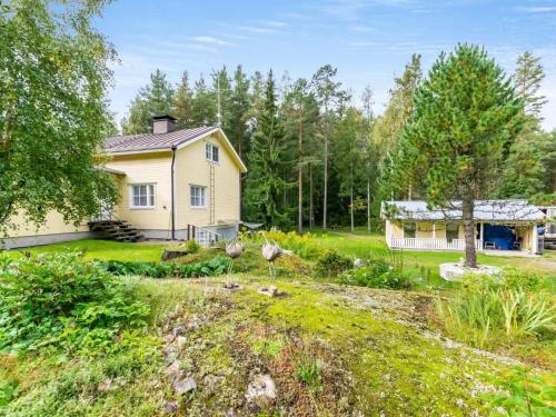 a home with a yard with a house at Holiday Home Halkoniemi by Interhome in Jämsä