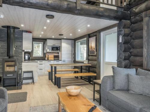 a living room with a couch and a table at Holiday Home Vaaranpää by Interhome in Meltaus