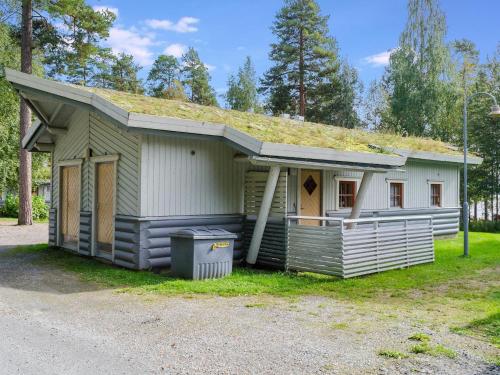 a small house with a grass roof on the side of it at Holiday Home Sotka 7 by bomba by Interhome in Nurmes