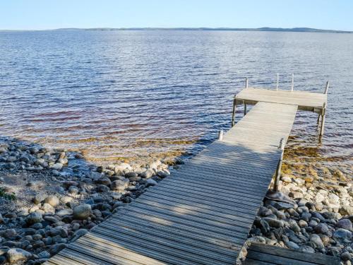 a wooden dock on a body of water at Holiday Home Honkakoli 4 by Interhome in Hattusaari