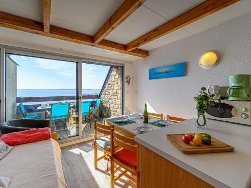 a kitchen and living room with a view of the ocean at Apartment Plein Océan-3 by Interhome in Carnac