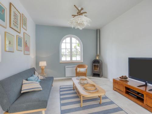 un soggiorno con un divano e una TV di Holiday Home Grande Ensouleihado by Interhome a Soulac-sur-Mer