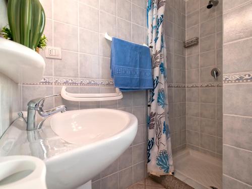 a bathroom with a sink and a shower at Apartment L'Oasi Trilo A5 by Interhome in Trinità dʼAgultu