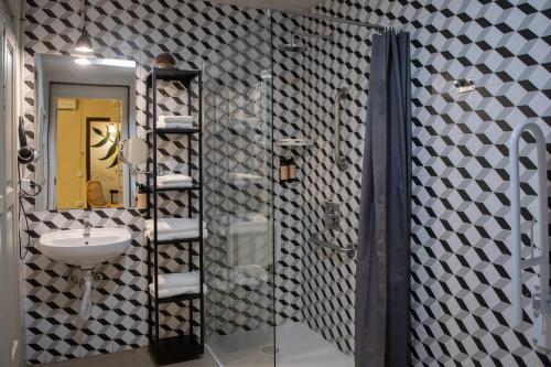 a bathroom with a glass shower and a sink at The Loft Hostel Barcelona La Pedrera in Barcelona