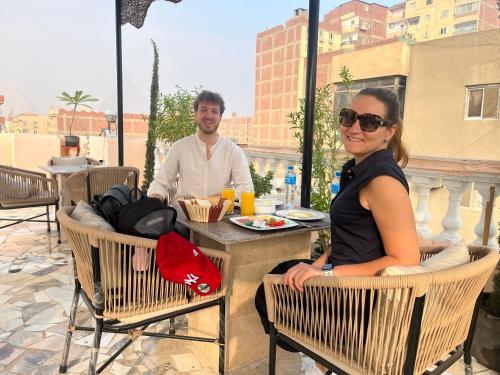 a man and a woman sitting at a table at Badr pyramids inn in Cairo