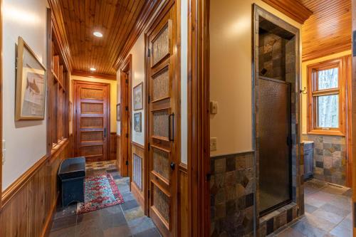 a hallway with wooden walls and a wooden door at Overlook Estate in The Farm in Banner Elk