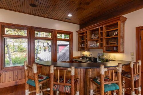 a kitchen with a large island in a log home at Overlook Estate in The Farm in Banner Elk