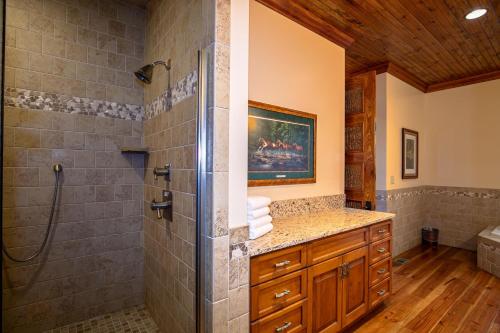 a bathroom with a shower and a sink at Overlook Estate in The Farm in Banner Elk