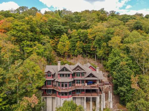 an aerial view of a house in the woods at Overlook Estate in The Farm in Banner Elk