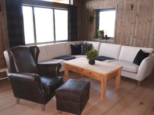 a living room with a couch and a coffee table at Holiday Home Sinnsro - VDS100 by Interhome in Ron