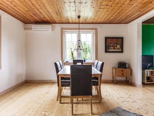 a dining room with a table and chairs at Holiday Home Älmegården by Interhome in Lammhult