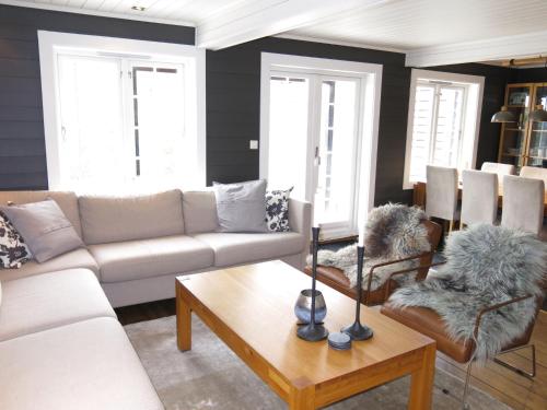 a living room with a couch and a table at Holiday Home Hovden - SET086 by Interhome in Hovden