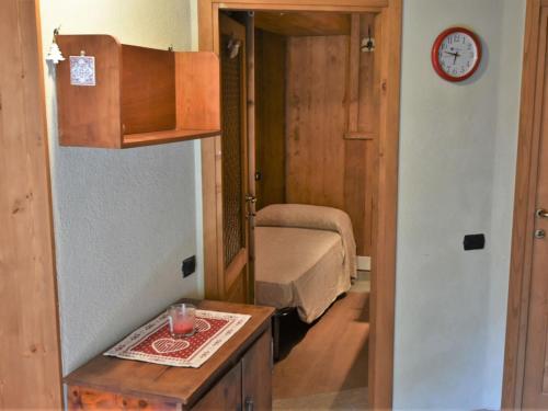 a small bedroom with a bed and a mirror at Apartment La Casetta di Biorca by Interhome in Tartano