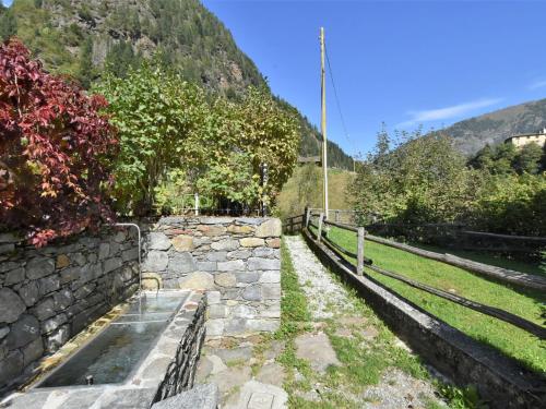 a stone wall next to a mountain at Apartment La Casetta di Biorca by Interhome in Tartano