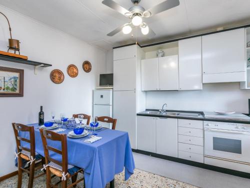 a kitchen with a table with a blue table cloth at Apartment La casa del Fale di Collodi by Interhome in Collodi