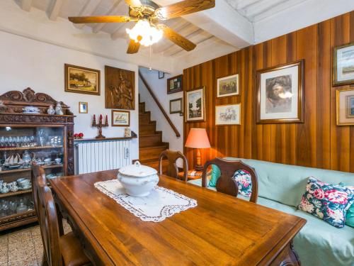a dining room with a table and a couch at Apartment La casa del Fale di Collodi by Interhome in Collodi