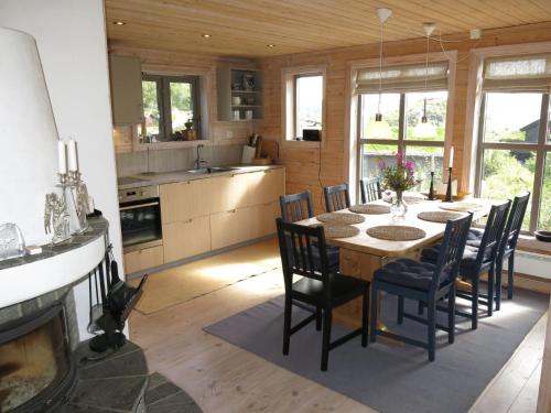 a kitchen and dining room with a table and chairs at Holiday Home Morgenro - SOW160 by Interhome in Åseral