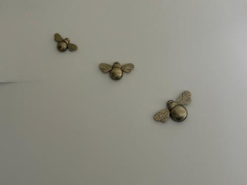 four bronze butterflies sitting on a white background at Modern 1 bed Flat with Private Courtyard in Newport