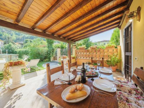 a wooden table with food on it on a patio at Holiday Home Oleandro by Interhome in Camaiore