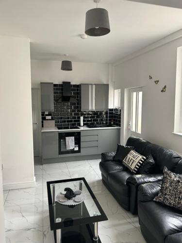 a living room with a couch and a coffee table at Modern 1 bed Flat with Private Courtyard in Newport