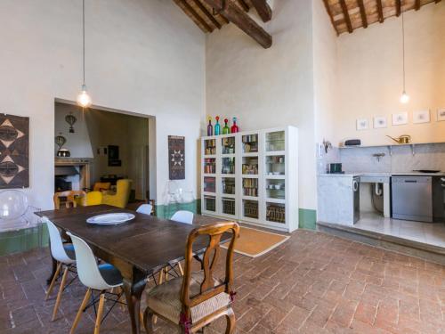 a dining room with a wooden table and chairs at Apartment Casa dei Granai by Interhome in Lorenzana