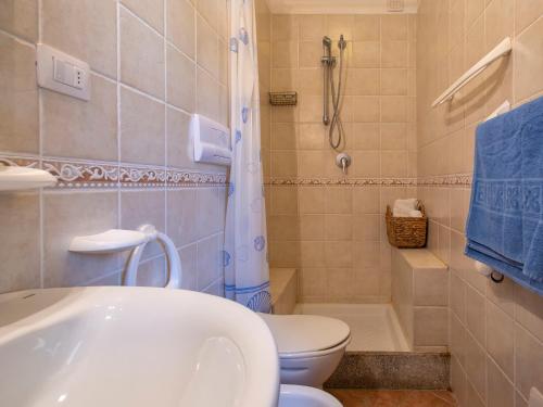 a bathroom with a toilet and a sink and a shower at Apartment L'Oasi Trilo A3 by Interhome in Trinità dʼAgultu