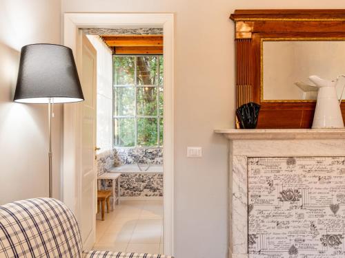 a living room with a fireplace and a mirror at Villa Eugenia by Interhome in Dervio