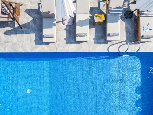 an overhead view of a swimming pool with a blue water at Cocoon Ocean Villa Luxury Escape in Peyia