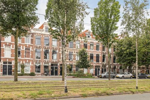 a large brick building with trees in front of it at BizStay Walden in The Hague