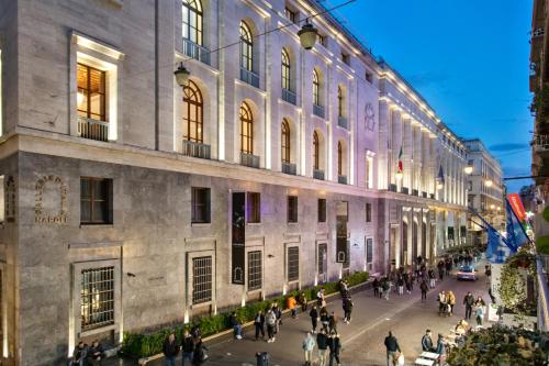 a group of people walking down a street in front of a building at Residenza Toledo Lifestyle in Naples