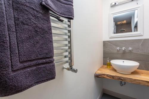 a bathroom with a sink and a mirror at Howgills House Hotel in Sedbergh