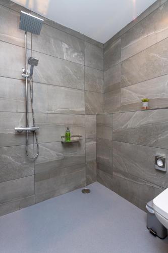 a bathroom with a shower with a sink and a toilet at Howgills House Hotel in Sedbergh